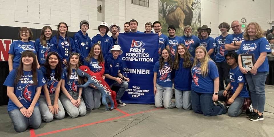 Image of GaCo Team 1629 posing with their championship banner.